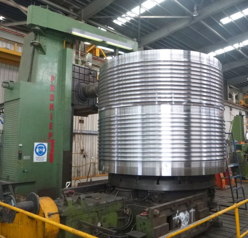 Large flanged ring component set up on a CNC vertical borer in the machining bay