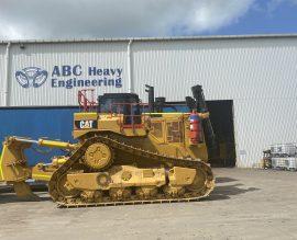 Caterpillar dozer parked in front of the ABC Heavy Engineering shed at Paget, ready for hire