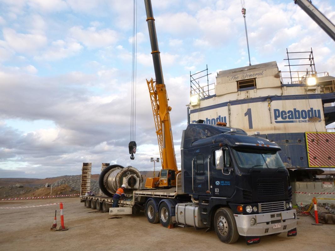 ABC branded prime mover delivering a drum assembly to the Peabody 1 dragline at dusk